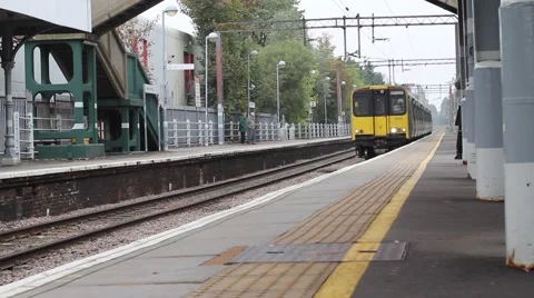 Train pulling into railway station platform in HIghams Park North East London Stock-Footage 58722854