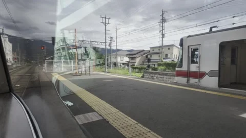 Train Pulling into Station &amp; Slow-moving Clouds Stock Footage 323912140
