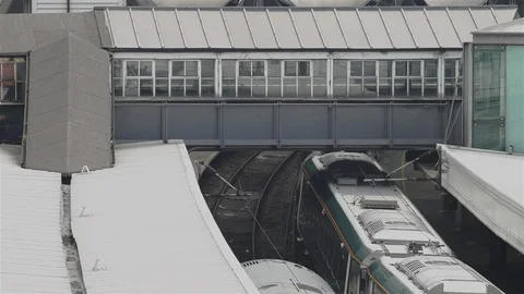 Train pulling into station. Walk way above with person walking, London Stock Footage 93210165