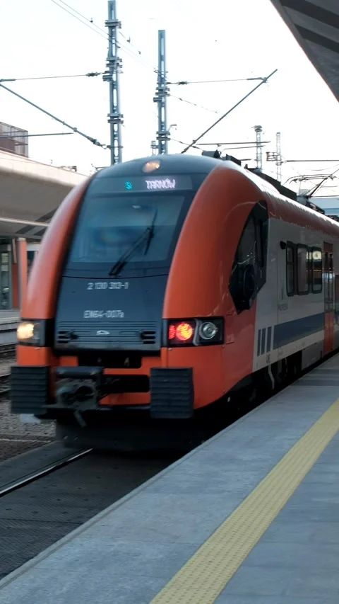 Train pulling into train station next to loading platform with train Stock Footage 306150027