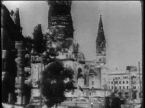 A train pulls up at Berlin station and, boats can be seen at a dock and men load Stock Footage 75008328