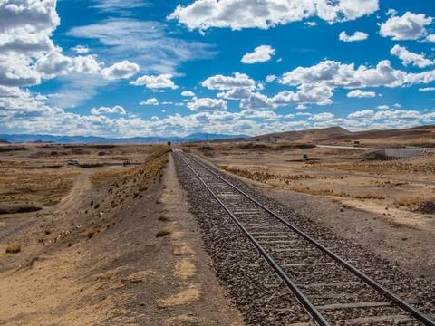 Train railroad under clouds in the sky Stock Photos