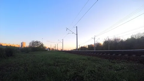 Train on rails at sunset in spring timelapse Stock Footage 82986530