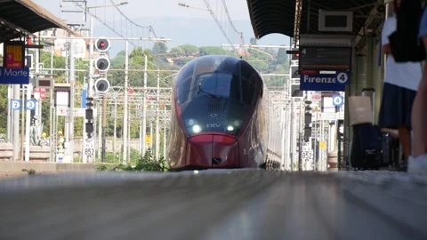 A Train at a Railway Station Arriving at the Platform With Several People Stock Footage 245428316