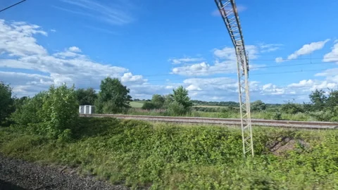 Train ride as a loaded freight train passes by on other side of railroad tracks Stock Footage 259991008