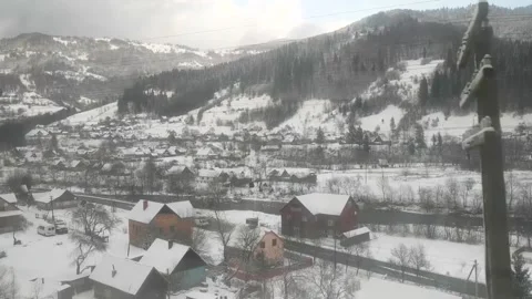 Train ride through snowy mountain region with clear view of alpine village Stock Footage 312648259