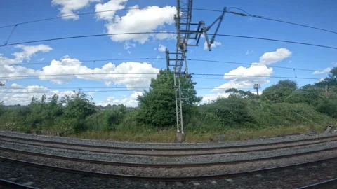 Train ride while a passenger train passes by on the other side of railway tracks Stock Footage 259990253