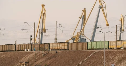 The train rides on the background of port cranes. Stock Footage 114289340