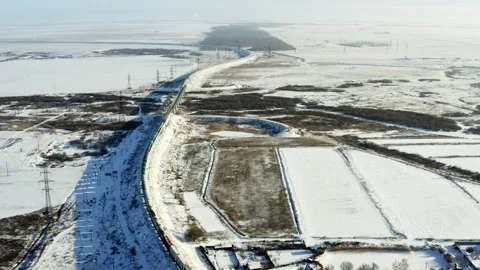 Train rides on rails in a field in winter Video stock 156599868