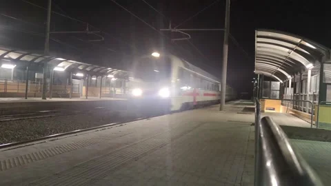 Train Rides on Rails at Night. The train travels through the Via Station. Stock Footage 194364639