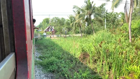 Train riding to Maeklong Station. View nature countryside drop off passenger Stock Footage 196268466