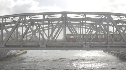 Train riding over Berlin Bridge in sunny light 100fps log Stock Footage 122932384