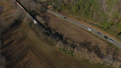 Train by road passes intersection Stock Footage 99807409