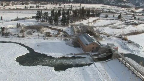 Train Rolling Past Icy River in Montana Stock Footage 106731851