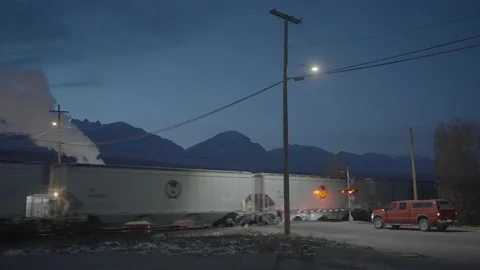 Train rolls through crossing with truck waiting at gate Stock Footage 225499551