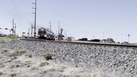 A Train Rumbles Down a Railroad Track Under a Clear Sky in Santa Fe, New Mexico Video stock 243224164