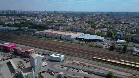 Train run at city industrial container port. Dramatic aerial view flight drone Stock Footage 311428248