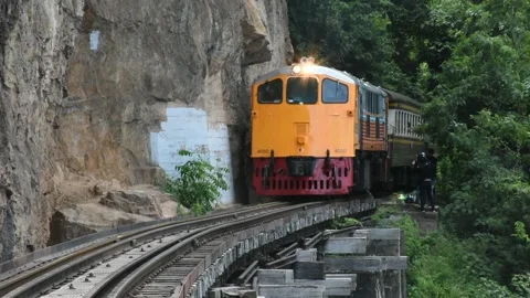 Train run on track at hellfire pass mountain station in Kanchanaburi, Thailand Stock Footage 156589224