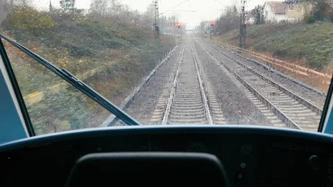 Train running from the driver's cabin on a rainy day Stock Footage 124473216