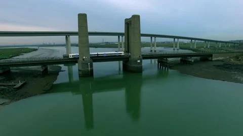Train Running over Bridge Spanning Thames River Estuary Aerial Drone Shot Stock Footage 196090701