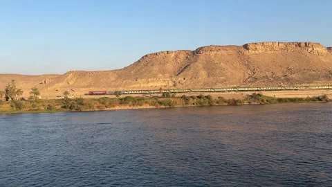 Train running parallel to the Nile River filmed from cruise ship Stock-Footage 315513642