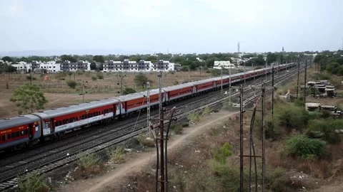 Train running on railroad track located in bhusawal, India in the summer Stock Footage 158093425