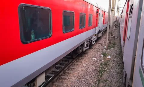 Train running on railway track with flat sky at morning from different angle Stock Photos