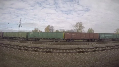 Train Running Through Small Ramshackle Village in Siberian Wilderness Stock Footage 81826656