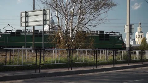 The train runs parallel to the road Stock Footage 163567202