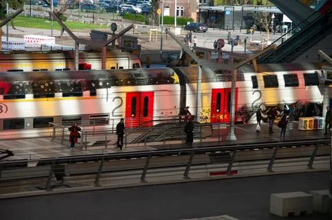 Train rushes past platform with blurred motion Stock Photos