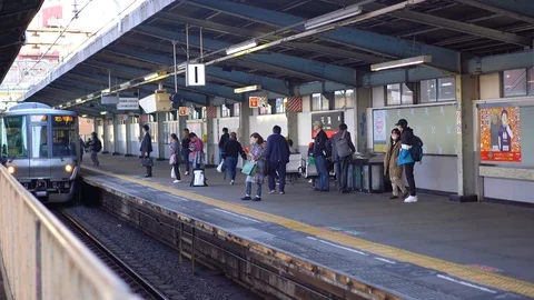 Train is seen arrival on inner Osaka loop line at Temma Station Stock Footage 99522262