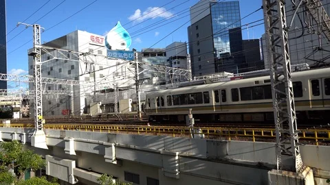 Train is seen on Osaka Loop line heading to Osaka Station Stock Footage 98991993