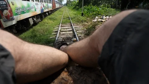 Train shot, swing the legs on a train in Yangon periphery, Burma, Asia in 4K Stock Footage 94713999