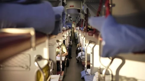 Train sleeper car aisle with passengers traveling long distance on railway Stock Footage 344697656