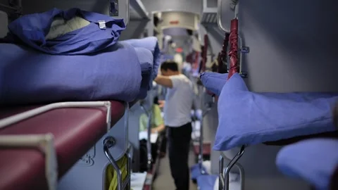Train sleeping car interior with bunks, passenger preparing for long journey Stock Footage 341701195