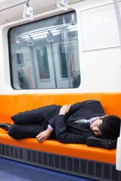 Train Sleeping Sleeping Leisure a man Tired Business people The Blue Man of the Stock Photos
