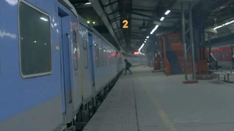 Train standing on a railway platform india Stock Footage 228197336