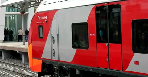 The train starts to move, starts moving, flashing red wagons Stock Footage 67470161