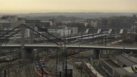 Train station and bridge in Ulm on cloudy morning time lapse Stock Footage 220765637