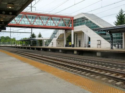 Train station with bridge over the train tracks Stock Photos