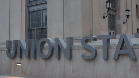 Train station commuter running past Union Station sign Toronto Video stock 246712210