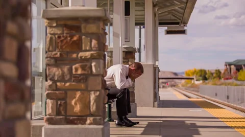 Train station man crying by himself Stock Footage 32243185