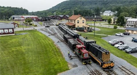 Train Station Operates With Freight Train During Mid-Day in a Small Town Wi.. Stock Photos