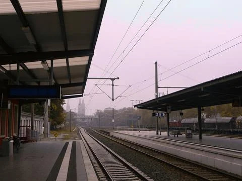 Train Station Platform a cloudy and rainy day with some city buildings back.. Stock Photos