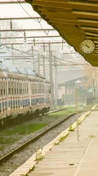 Train station platform with an old train , clock, symbolizing time and journe Foto stock