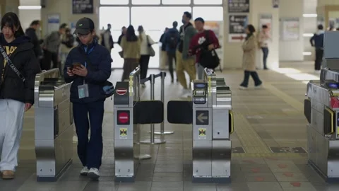 Train station ticket gates with passengers in Kyoto Japan Stock Footage 334793236