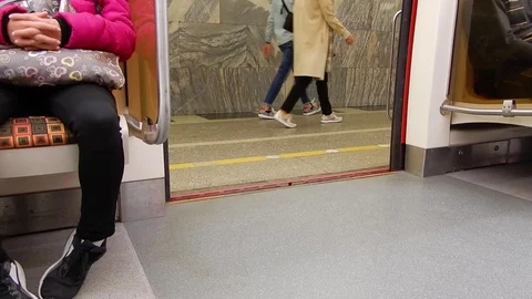 Train stop on subway station. Opening doors in carriage of subway train. Stock Footage 116332850