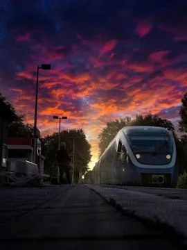 Train stops at the station at sunset Stock-Fotos