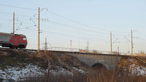 Train at sunset passes over the bridge Stock Footage 124495410
