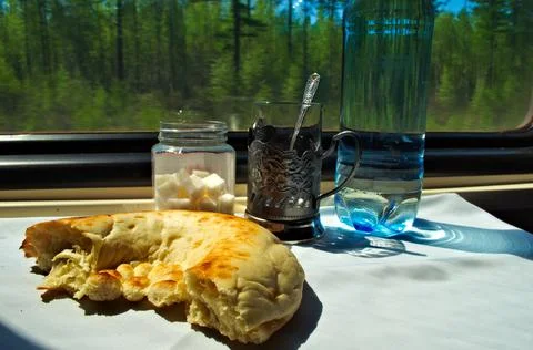 Train table with bread and glass and water moving background 库存照片